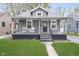 Charming gray home with a covered front porch, green lawn, and easy access walkway at 4719 Evanston Ave, Indianapolis, IN 46205