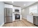 Well-appointed kitchen with stainless steel appliances, sleek white cabinets, and ample counter space at 4719 Evanston Ave, Indianapolis, IN 46205