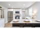 Modern kitchen boasts stainless steel appliances, white cabinets, and a stylish breakfast bar at 4719 Evanston Ave, Indianapolis, IN 46205