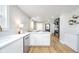 Bright kitchen featuring white cabinets, stainless steel appliances, hardwood floors, and recessed lighting at 4719 Evanston Ave, Indianapolis, IN 46205