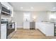 A modern kitchen featuring stainless steel appliances, white cabinets, and plenty of counter space at 4719 Evanston Ave, Indianapolis, IN 46205