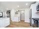 Open kitchen design with white cabinets, hardwood floors, stainless steel appliances, and recessed lighting at 4719 Evanston Ave, Indianapolis, IN 46205