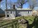 Fenced backyard featuring a circular stone fire pit at 4823 Atwell Dr, Lawrence, IN 46226