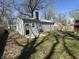 Cozy backyard featuring a fire pit, shed, and mature trees at 4823 Atwell Dr, Lawrence, IN 46226