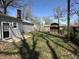 Fenced backyard featuring a wooden shed and a stone fire pit at 4823 Atwell Dr, Lawrence, IN 46226