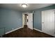 Bedroom with hardwood floors, blue walls, and white trim at 4823 Atwell Dr, Lawrence, IN 46226