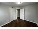 Bedroom with wood-look floors, doors to other rooms, and neutral-colored walls at 4823 Atwell Dr, Lawrence, IN 46226