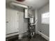 View of the gray furnace and utility connections at 4823 Atwell Dr, Lawrence, IN 46226