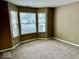 Bedroom with neutral walls and carpeting, plus three windows for plenty of natural light at 5129 W Preakness Ct, Muncie, IN 47304