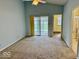 Spacious carpeted bedroom with sliding doors to a patio, and attached bathroom at 5129 W Preakness Ct, Muncie, IN 47304