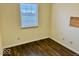 Neutral bedroom with hardwood floors and window offering natural light at 5129 W Preakness Ct, Muncie, IN 47304
