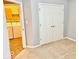 This bedroom features a double door closet, neutral carpet, and access to the laundry room at 5129 W Preakness Ct, Muncie, IN 47304