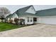 Well-maintained, one-story home featuring a large driveway and a green roof at 5129 W Preakness Ct, Muncie, IN 47304
