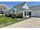 Beautiful white home with lush green lawn and meticulously landscaped front yard at 5129 W Preakness Ct, Muncie, IN 47304