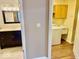 Shot of hallway leading to bathroom on left and laundry room with utility sink on right at 5129 W Preakness Ct, Muncie, IN 47304