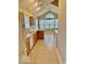 Open kitchen and dining area with light wood cabinets, an island, and vaulted ceilings at 5129 W Preakness Ct, Muncie, IN 47304