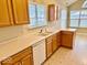Bright kitchen featuring a double sink, oak cabinetry and plenty of counter space at 5129 W Preakness Ct, Muncie, IN 47304