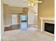 Inviting living room with a fireplace, hardwood floors, and plush carpet at 5129 W Preakness Ct, Muncie, IN 47304