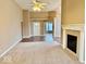 Open living room featuring a fireplace, hardwood floors, and plush carpet at 5129 W Preakness Ct, Muncie, IN 47304