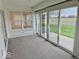 Sunroom with carpet and sliding glass doors that lead to outdoor space and backyard at 5129 W Preakness Ct, Muncie, IN 47304