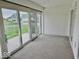 Sunroom with carpet and sliding glass doors that lead to outdoor space and backyard at 5129 W Preakness Ct, Muncie, IN 47304