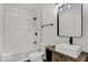 Modern bathroom with tiled shower-tub combo and wood-grain vanity at 514 Spruce St, Indianapolis, IN 46203