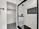 Contemporary bathroom features a glass shower, decorative tile, and access to a closet for added convenience at 514 Spruce St, Indianapolis, IN 46203