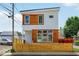 Eye-catching two-story home featuring white siding and wood accents under a bright blue sky at 514 Spruce St, Indianapolis, IN 46203