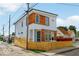 Modern two-story home with a white exterior, wood accents, and a stylish wood fence at 514 Spruce St, Indianapolis, IN 46203