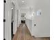 Bright hallway with hardwood floors, modern lighting, and access to various rooms creates an inviting passage at 514 Spruce St, Indianapolis, IN 46203
