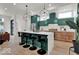 Modern kitchen boasts an island with bar seating, pendant lighting, and stainless steel appliances at 514 Spruce St, Indianapolis, IN 46203