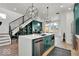 Open kitchen featuring quartz counters, modern light fixtures, stainless appliances, and a convenient breakfast bar at 514 Spruce St, Indianapolis, IN 46203