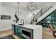 Open kitchen featuring quartz counters, stainless appliances, modern lighting and view of the staircase at 514 Spruce St, Indianapolis, IN 46203