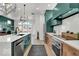 Bright kitchen showcasing a quartz countertop island, stainless steel appliances, and light hardwood floors at 514 Spruce St, Indianapolis, IN 46203
