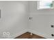 Cozy laundry room features modern wood flooring and white walls at 514 Spruce St, Indianapolis, IN 46203