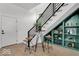 Stylish staircase featuring black rails, hardwood floors, and built-in green shelving at 514 Spruce St, Indianapolis, IN 46203