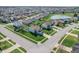 An aerial view of home, lush green yard, and view of the neighborhood pond at 5209 Twin Bridge Blvd, Indianapolis, IN 46239
