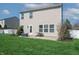 View of backyard with green lawn, patio, and house exterior at 5209 Twin Bridge Blvd, Indianapolis, IN 46239