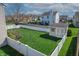A lush backyard featuring a well-maintained lawn, white picket fence and a storage shed at 5209 Twin Bridge Blvd, Indianapolis, IN 46239