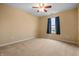 Cozy bedroom with carpet, ceiling fan, window and light-colored walls at 5209 Twin Bridge Blvd, Indianapolis, IN 46239
