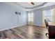 Bedroom featuring hard wood floors, blue walls, tv mounting hardware and bright windows at 5209 Twin Bridge Blvd, Indianapolis, IN 46239