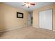 Spacious bedroom featuring neutral carpeting, ceiling fan and large double door closet at 5209 Twin Bridge Blvd, Indianapolis, IN 46239