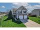 Inviting two-story home with a well-maintained lawn and a two-car garage at 5209 Twin Bridge Blvd, Indianapolis, IN 46239