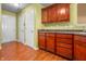 Updated kitchen featuring dark wood cabinets, modern countertops, and easy access to the entryways at 5209 Twin Bridge Blvd, Indianapolis, IN 46239