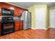 Well-equipped kitchen with stainless steel appliances, ample counter space, and dark wood cabinetry at 5209 Twin Bridge Blvd, Indianapolis, IN 46239