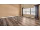 Neutral living room with hardwood floors and three large windows at 5209 Twin Bridge Blvd, Indianapolis, IN 46239