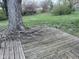 Backyard with a wooden deck and surrounding green space, perfect for relaxation and outdoor activities at 5240 Regency Dr, Columbus, IN 47203