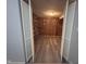 Spacious storage room featuring wood paneling and shelving, accessible through white bi-fold doors at 5240 Regency Dr, Columbus, IN 47203
