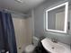 The recently remodeled bathroom features a modern sink and vanity, plus a shower with tub at 5240 Regency Dr, Columbus, IN 47203