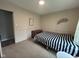 Neutral bedroom with carpet, a bed, an accent wall hanging, and a chest of drawers at 5240 Regency Dr, Columbus, IN 47203